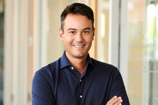 Alex Lim wearing a dress shirt with arms crossed