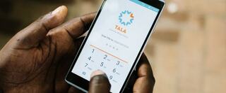 hands holding mobile phone with Tala on screen